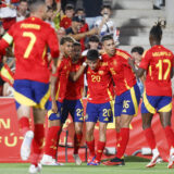 Spain's Pedri, center, is congratulated after scoring his side's first goal during the international friendly soccer match between Spain and Northern Ireland at the Son Moix stadium in Palma de Mallorca, Spain, Saturday, June 8, 2024. (AP Photo/Francisco Ubilla)