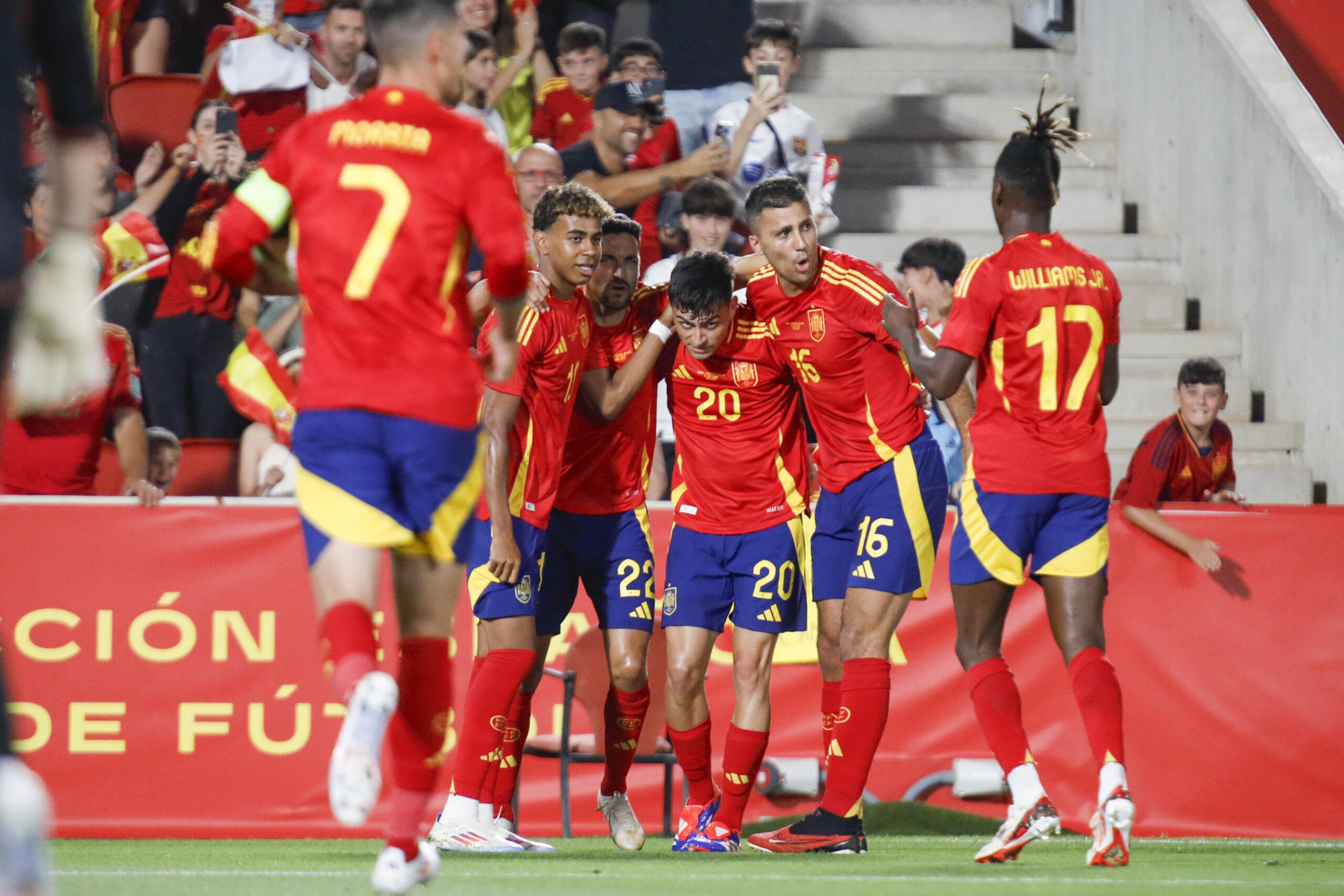 Spain's Pedri, center, is congratulated after scoring his side's first goal during the international friendly soccer match between Spain and Northern Ireland at the Son Moix stadium in Palma de Mallorca, Spain, Saturday, June 8, 2024. (AP Photo/Francisco Ubilla)