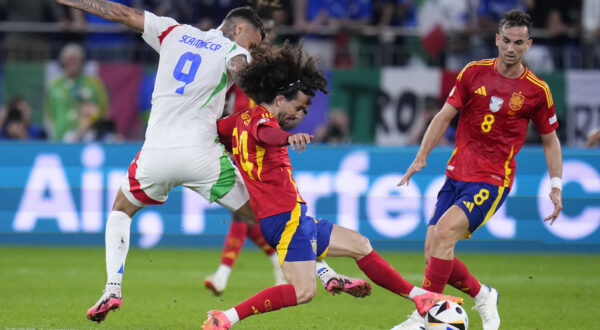 Spain's Marc Cucurella (24) and Italy's Gianluca Scamacca (9) battle for the ball during a Group B match between Spain and Italy at the Euro 2024 soccer tournament in Gelsenkirchen, Germany, Thursday, June 20, 2024. (AP Photo/Manu Fernandez)