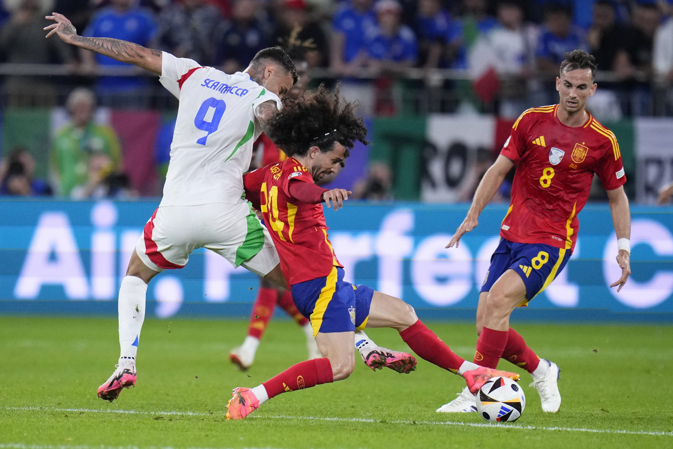 Spain's Marc Cucurella (24) and Italy's Gianluca Scamacca (9) battle for the ball during a Group B match between Spain and Italy at the Euro 2024 soccer tournament in Gelsenkirchen, Germany, Thursday, June 20, 2024. (AP Photo/Manu Fernandez)
