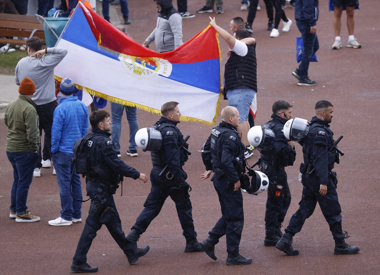 Police officers patrol as supporters arrive at the Arena AufSchalke ahead of the UEFA Euro 2024 Group C football match between Serbia and England in Gelsenkirchen on June 16, 2024. Gelsenkirchen has been declared high risk by the police due to fears Serbian ultras could clash with the tens of thousands of England fans that have made the trip to north-west Germany.,Image: 882124836, License: Rights-managed, Restrictions: , Model Release: no, Credit line: Kenzo TRIBOUILLARD / AFP / Profimedia