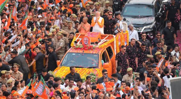 epa11336936 Top Bhartya Janta party (BJP) leader and Indian Prime Minister Narendra Modi (R) and Chief Minsiter of Uttar Pradesh, Yogi Adityanath (L) gesture to their supporters during a road show in Varanasi, Uttar Pradesh, India, 13 May 2024. Prime Minister Narendra Modi will file his election nomination on 14 May 2024, from the Varanasi constituency for the parliamentary or general elections for India's 545-member lower house of parliament, or Lok Sabha, that is held every five years. The Indian general elections are held in seven phases between 19 April and 01 June 2024, with the results announced on 04 June 2024.  EPA/HARISH TYAGI