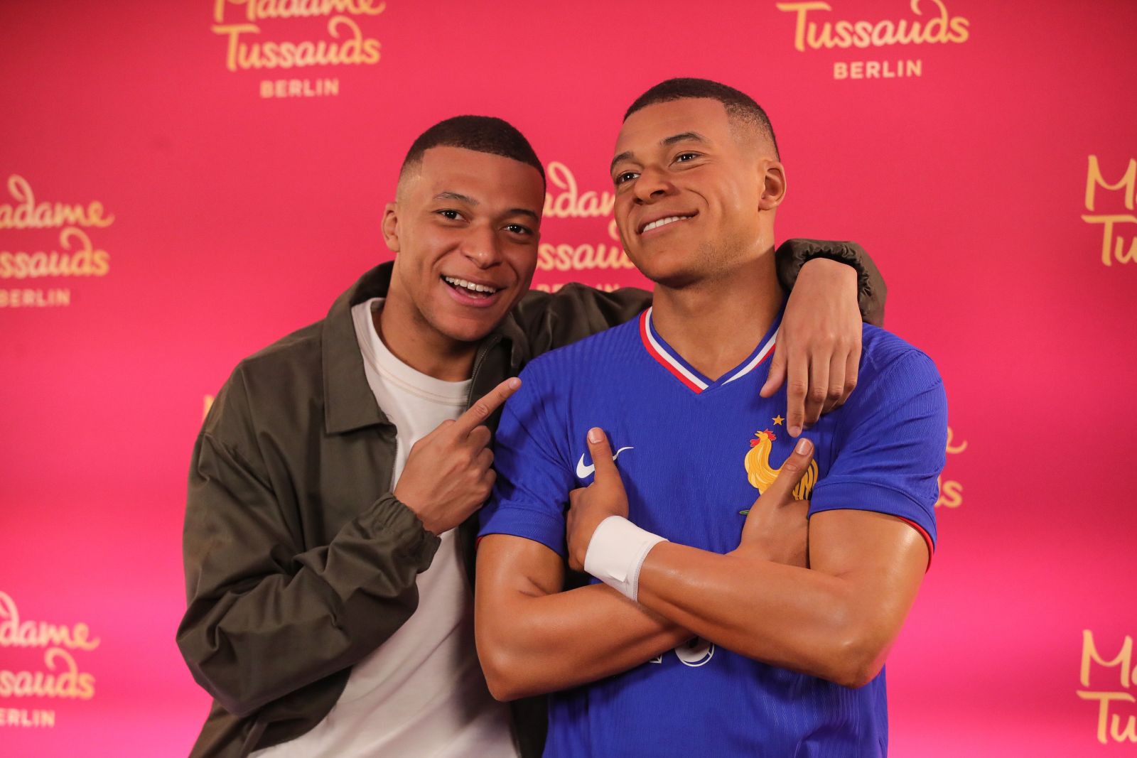 epa11345316 French soccer player Kylian Mbappe (L) poses with his Madame Tussauds wax figure during the unveiling in Paris, France, 16 May 2024. The Madame Tussauds museum will move the Mappe wax figure to it's Berlin, Germany, location at a later date.  EPA/Teresa Suarez