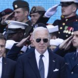 epa11394632 US President Joe Biden (C) and French President Emmanuel Macron (L) arrive to attend a commemorative ceremony for the 80th anniversary of D-Day landings in Normandy at American War Cemetery in Colleville-sur-Mer, France, 06 June 2024. More than 160,000 Western allied troops landed on beaches in Normandy on 06 June 1944 launching the liberation of Western Europe from Nazi occupation during World War II.  EPA/ANDRE PAIN