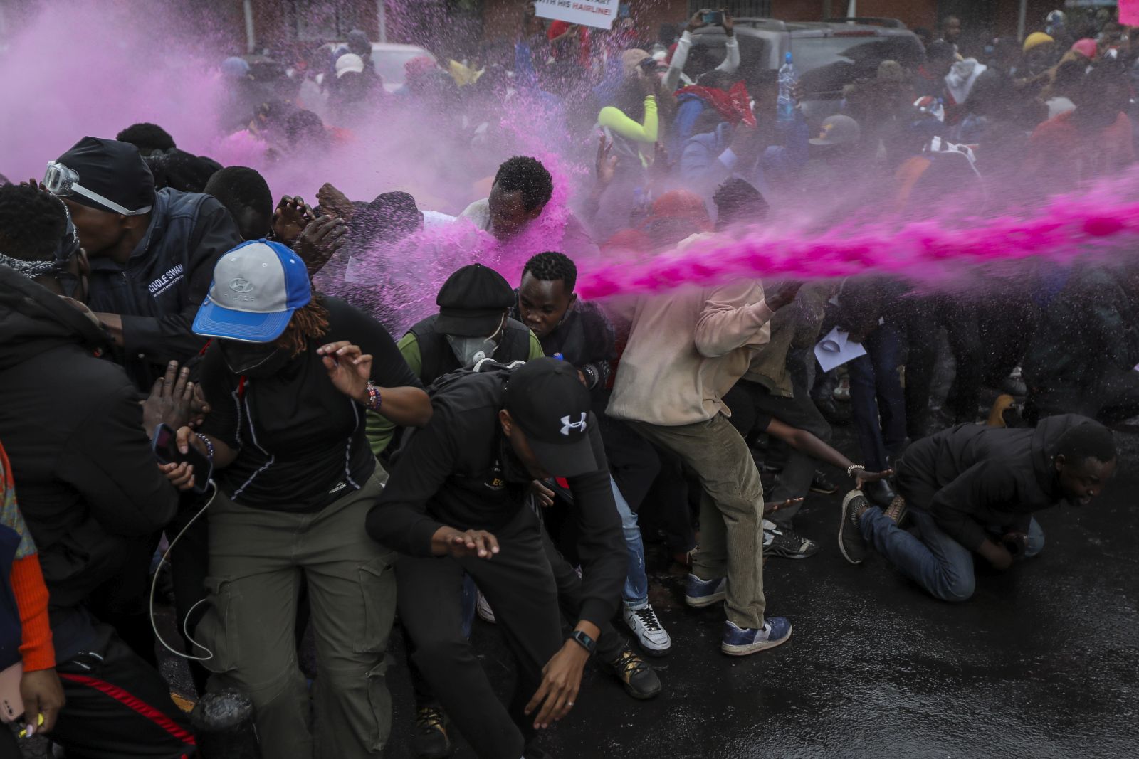 epa11426976 Protesters are pushed away by a water canon used to disperse them as they took part in a demonstration against a controversial tax bill in the central business district in Nairobi, Kenya, 20 June 2024. Police have fired tear gas to disperse protesters who gathered near the parliament to demonstrate against planned tax hikes that many fear will worsen the cost-of-living crisis.  EPA/DANIEL IRUNGU