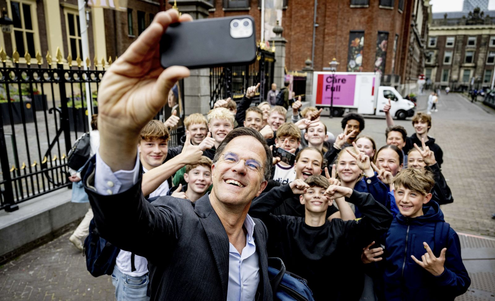 epa11427332 Dutch outgoing Prime Minister Mark Rutte (front) takes a selfie picture with youths as he arrives at the Binnenhof for the Council of Ministers, in the Hague, Netherlands, 21 June 2024. Rutte will chair the weekly cabinet of ministers for the last time on 21 June, after Dick Schoof was nominated to succeed Rutte as prime minister at the end of May 2024. Rutte, who is the only candidate left running for NATO's top job of secretary general after Romanian President Iohannis announced he was withdrawing his candidacy, has yet to be officially confirmed by NATO member states.  EPA/ROBIN UTRECHT