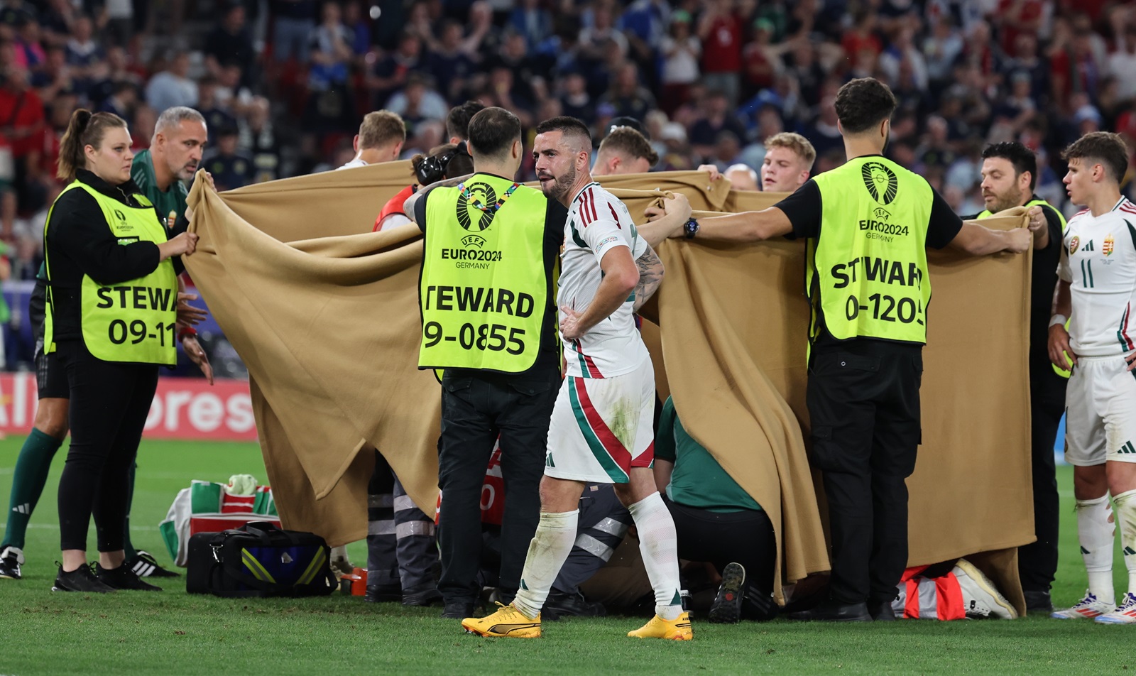 epa11433167 Barnabas Varga (hidden) of Hungary receives medical treatment after a collision during the UEFA EURO 2024 Group A soccer match between Scotland and Hungary, in Stuttgart, Germany, 23 June 2024.  EPA/MOHAMED MESSARA