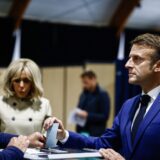 epa11446894 French President Emmanuel Macron (R), next to his wife Brigitte Macron (C), casts his ballot in the first round of the early French parliamentary elections, in Le Touquet-Paris-Plage, northern France, 30 June 2024. France on 30 June holds the first round of snap parliamentary elections called by President Emmanuel Macron, after dissolving the National Assembly on 09 June 2024.  EPA/YARA NARDI / POOL  MAXPPP OUT
