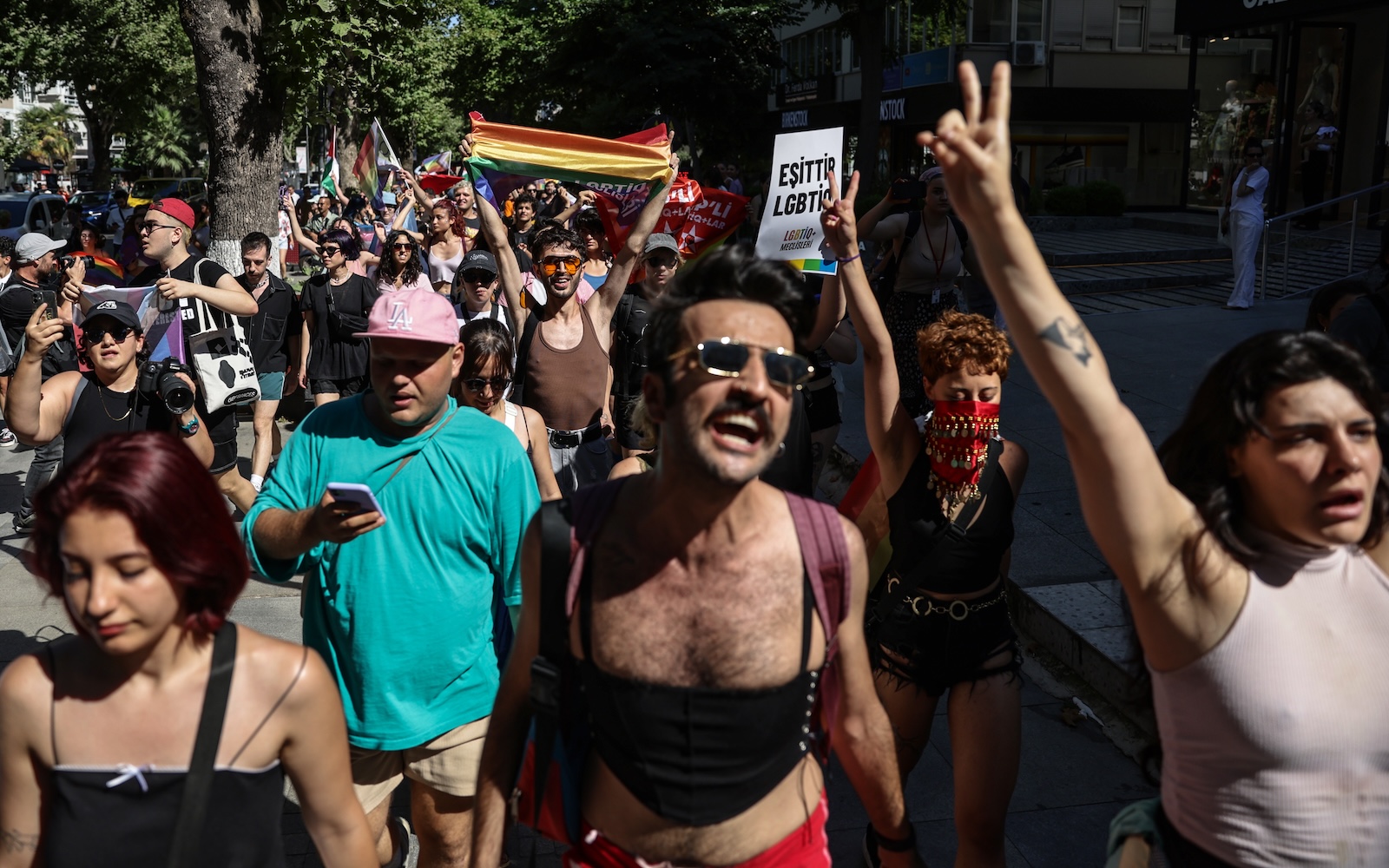 epa11447341 Members of LGBTIQ+ community wave rainbow-colored flags and shout slogans during the Pride March in Istanbul, Turkey, 30 June 2024. The Turkish Government has banned the Istanbul Pride March as they already did in previous years.  EPA/ERDEM SAHIN