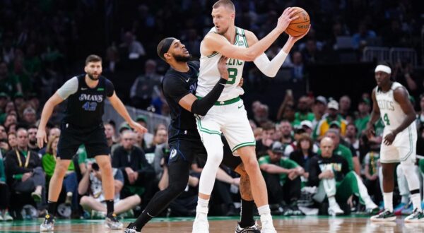 Jun 6, 2024; Boston, Massachusetts, USA; Boston Celtics center Kristaps Porzingis (8) controls the ball against Dallas Mavericks center Daniel Gafford (21) in the first quarter during game one of the 2024 NBA Finals at TD Garden. Mandatory Credit: David Butler II-USA TODAY Sports Photo: David Butler II/REUTERS