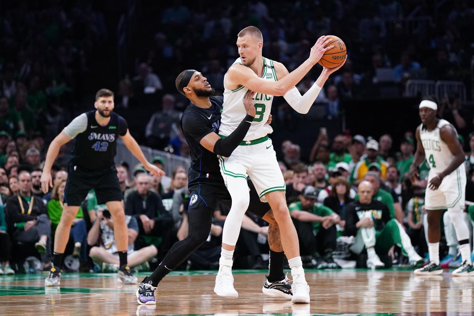 Jun 6, 2024; Boston, Massachusetts, USA; Boston Celtics center Kristaps Porzingis (8) controls the ball against Dallas Mavericks center Daniel Gafford (21) in the first quarter during game one of the 2024 NBA Finals at TD Garden. Mandatory Credit: David Butler II-USA TODAY Sports Photo: David Butler II/REUTERS