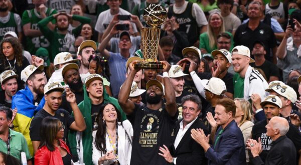 Jun 17, 2024; Boston, Massachusetts, USA; Boston Celtics guard Jaylen Brown (7) holds up the Larry O'Brien Championship Trophy after the Celtics beat the Dallas Mavericks in game five of the 2024 NBA Finals at the TD Garden. Mandatory Credit: Brian Fluharty-USA TODAY Sports Photo: Brian Fluharty/REUTERS