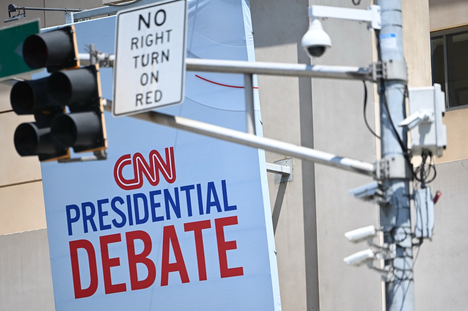 CNN signage near a traffic light with security cameras is displayed outside the studios at the Turner Entertainment Networks as Atlanta prepares one day ahead of the first 2024 presidential debate between US President Joe Biden and former President Donald Trump, on June 26, 2024.,Image: 884963881, License: Rights-managed, Restrictions: , Model Release: no, Credit line: ANDREW CABALLERO-REYNOLDS / AFP / Profimedia
