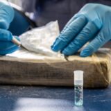 11 July 2022, Bavaria, Munich: A customs officer takes a sample from part of the cocaine seized for the largest single seizure of cocaine in Bavaria to date, which is examined using a test tube. Representatives of the Joint Narcotics Investigation Group (JIT) Northern Bavaria, the Customs Investigation Office in Munich, the Bavarian State Criminal Police Office and the Public Prosecutor's Office in Aschaffenburg were involved in the operation. Photo: Peter Kneffel/dpa,Image: 707381640, License: Rights-managed, Restrictions: , Model Release: no, Credit line: Peter Kneffel / DPA / Profimedia