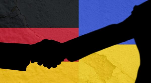 Silhouette of two men shaking hands against ukraine and germany flag background. international relations concept,Image: 675789701, License: Royalty-free, Restrictions: , Model Release: no, Credit line: - / Wavebreak / Profimedia