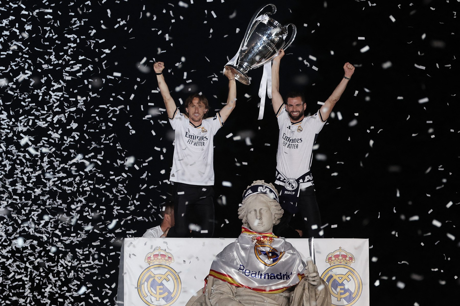 Real Madrid's Croatian midfielder #10 Luka Modric (L) and Real Madrid's Spanish defender #06 Nacho Fernandez celebrate with the trophy their 15th Champions League win, one day after beating Borussia Dortmund in London, on Cibeles square in Madrid on June 2, 2024.,Image: 878382646, License: Rights-managed, Restrictions: , Model Release: no, Credit line: Thomas COEX / AFP / Profimedia
