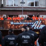 Netherlands supporters face German police officers as they gather at the famous Hamburg amusement mile 