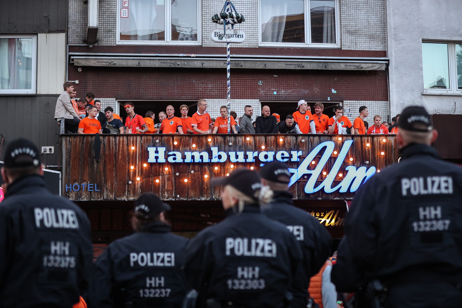 Netherlands supporters face German police officers as they gather at the famous Hamburg amusement mile "Reeperbahn" in Hamburg, northern Germany, on June 15, 2024, on the eve of the UEFA Euro 2024 football match between Poland and Netherlands.,Image: 882030306, License: Rights-managed, Restrictions: , Model Release: no, Credit line: Ronny Hartmann / AFP / Profimedia