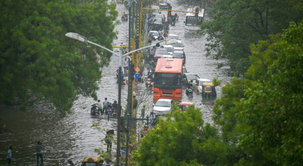 Commuters wade through flooded streets after heavy rains in New Delhi on June 28, 2024.,Image: 885436665, License: Rights-managed, Restrictions: , Model Release: no, Credit line: Arun SANKAR / AFP / Profimedia
