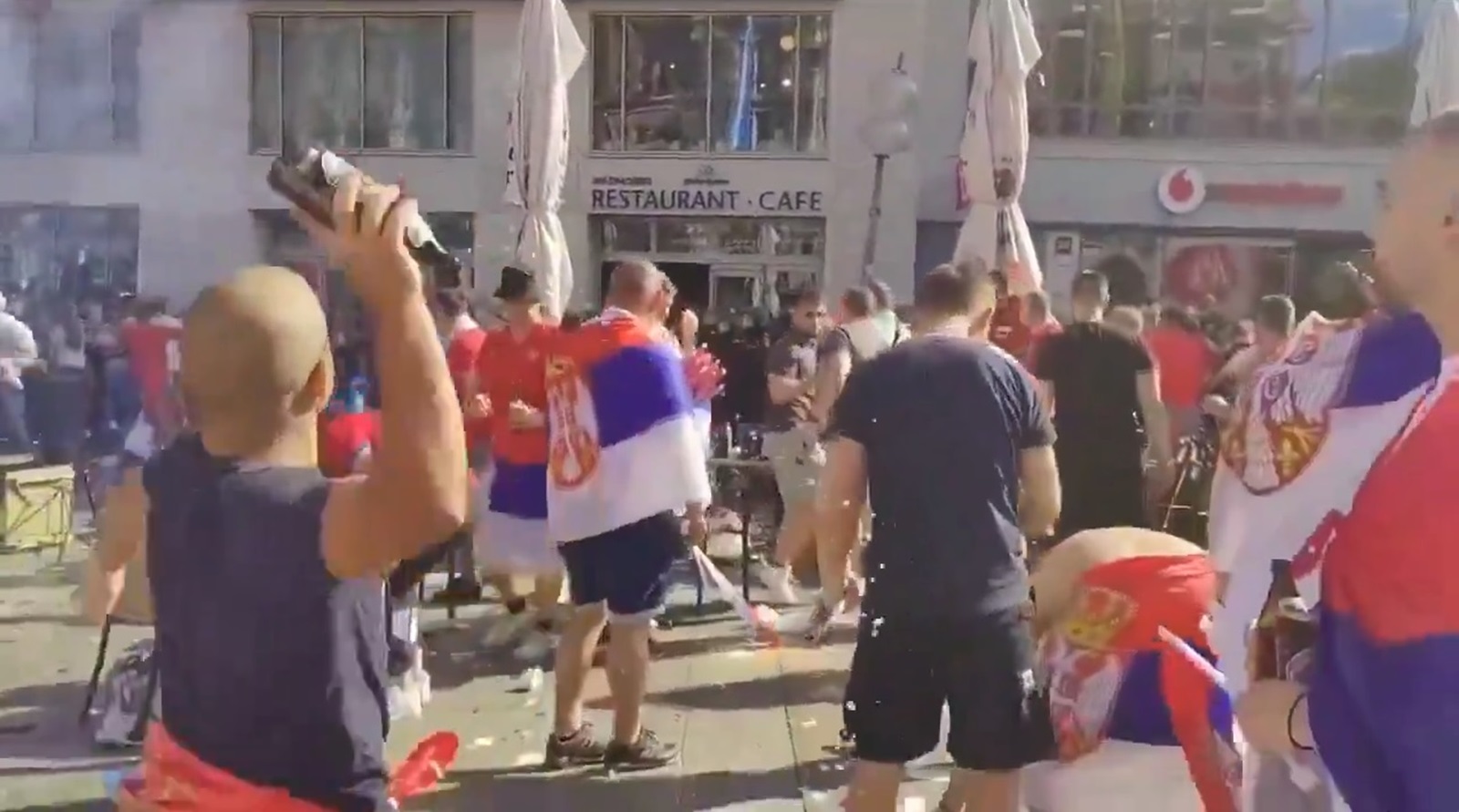 Story from Jam Press (Serbian Fans Throw Bottles) 

Pictured: A video grab of Serbian football thugs lobbing beer bottles at German riot cops.

VIDEO: Serbian footy thugs lob beer bottles at German cops in ugly Euro 2024 scenes

Serbian football thugs lobbed beer bottles at German riot cops in ugly scenes at Euro 2024.

A mob of supporters targeted the police officers in the main square in Munich.

It was ahead of their match last (25 Jun) night with Denmark that ended 0-0.

Serbia, in Group C along with England, were knocked out after finishing bottom.

Some of their fans were topless, while others were clad in their football shirts and draped in their national flag.

But as officers moved in to make an arrest, the mob turned on the cops.

Beer bottles were hurled at them in the shocking clashes in the picturesque Marienplatz.

Pints were seen on the tables in the street after theyâ??d been boozing in the pretty square before kick-off.

Theyâ??d been drinking outside a bar sandwiched between two mobile phone shops.

England fan, Alan Sawyer fumed: â??Serbia thugs.â?ť

One West Ham follower, called Ashley, joked: â??But the England fans sang a song about the war.â?ť

Another added: â??Clowns go home.â?ť

Chris said: â??Forever throwing bottles.â?ť

It comes after a video emerged last Thursday (21 Jun) of Serbia fans pushing a man off a train, also in Munich.

The clash happened before their 1-1 draw with Slovenia, as reported by NeedToKnow.

England beat Serbia 1-0 on Sunday (16 Jun) â?? their opening match.

There were eight arrests after clashes between rival supporters in Gelsenkirchen.

ENDS

EDITOR'S NOTE: Video Usage Licence: (NON-EXCLUSIVE) We have obtained a non-exclusive licence from the copyright holder. A copy of the licence is available on request.

Video Restrictions: None.,Image: 884801942, License: Rights-managed, Restrictions: , Model Release: no, Credit line: Jam Press / Jam Press / Profimedia