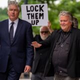 WASHINGTON, DC - JUNE 6: A man holds a sign that reads "Lock Them Up" as Attorney Matthew Evan Corcoran (L) and Steve Bannon, former advisor to President Donald Trump, depart federal court on June 6, 2024 in Washington, DC. Bannon has been ordered to begin serving his four-month prison sentence on July 1 for two counts of contempt of Congress after failing to comply with a congressional subpoena related to the Jan. 6, 2021, attack on the U.S. Capitol.   Andrew Harnik,Image: 879436414, License: Rights-managed, Restrictions: , Model Release: no, Credit line: Andrew Harnik / Getty images / Profimedia