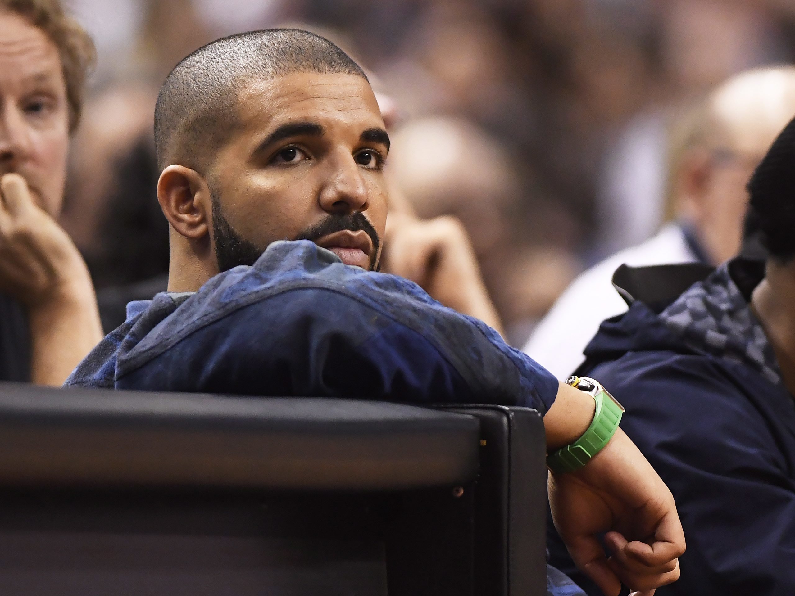 Rapper Drake watches the action between the Toronto Raptors and the Cleveland Cavaliers during the second half of Game 3 of an NBA basketball second-round playoff series in Toronto on Friday, May 5, 2017. (Frank Gunn/The Canadian Press via AP)