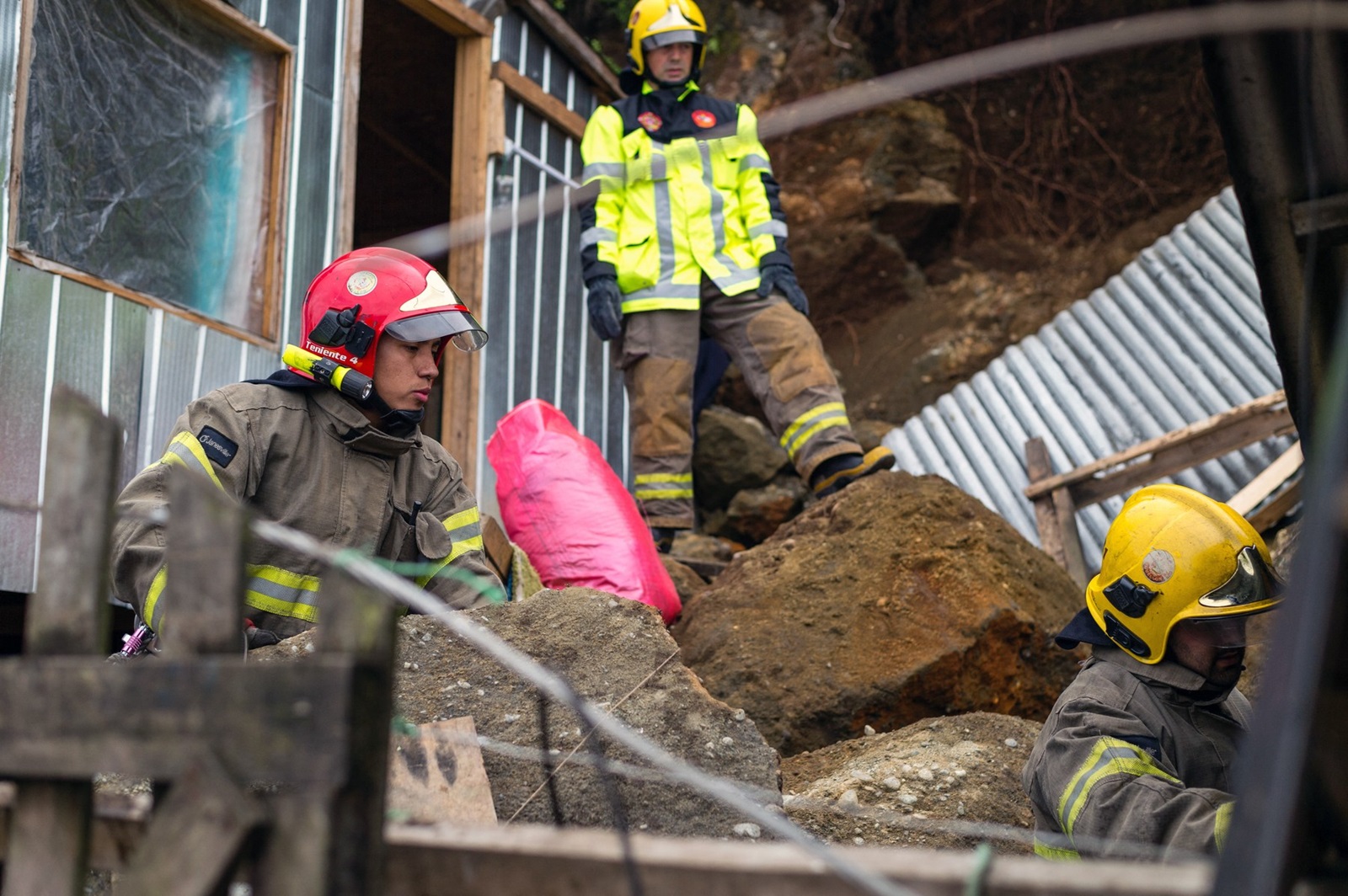 Firefighters help to clean up debris from destroyed buildings after a 7.7-magnitude earthquake shook Chiloe Island off the Pacific coast of southern Chile, on December 26, 2016.
 A strong Christmas day earthquake rattled Chile on Sunday, registering 7.7 on the Moment Magnitude Scale, according to US seismologists, who warned that tsunamis were possible in some areas. No victims were reported.,Image: 309491358, License: Rights-managed, Restrictions: , Model Release: no, Credit line: PAOLO AVILA / AFP / Profimedia