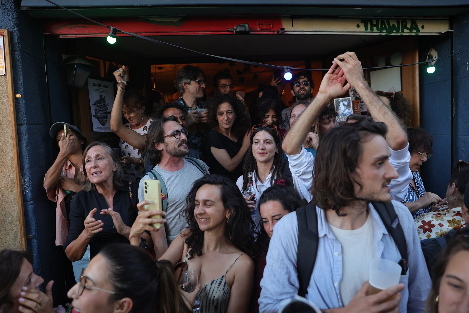 epa11465676 French people react after the second round of the legislative elections results in Marseille, Southern France, 07 July 2024.  France voted on 07 July for the second round of the legislative elections. According to the first official results, the leftist alliance Le Nouveau Front Populaire came ahead of the French President Macron party and the extreme right one the  Rassemblement national (RN).  EPA/TERESA SUAREZ