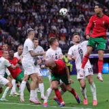 epa11451249 Cristiano Ronaldo of Portugal (R) in action during the UEFA EURO 2024 Round of 16 soccer match between Portugal and Slovenia, in Frankfurt Main, Germany, 01 July 2024.  EPA/OLIVIER MATTHYS