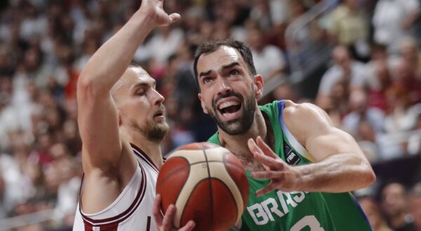 epaselect epa11465529 Kristers Zoriks of Latvia (L) in action against Vitor Benite of Brazil (R) during the FIBA Olympic Qualifying Tournament final match Latvia vs Brazil in Riga, Latvia, 07 July 2024.  EPA/TOMS KALNINS