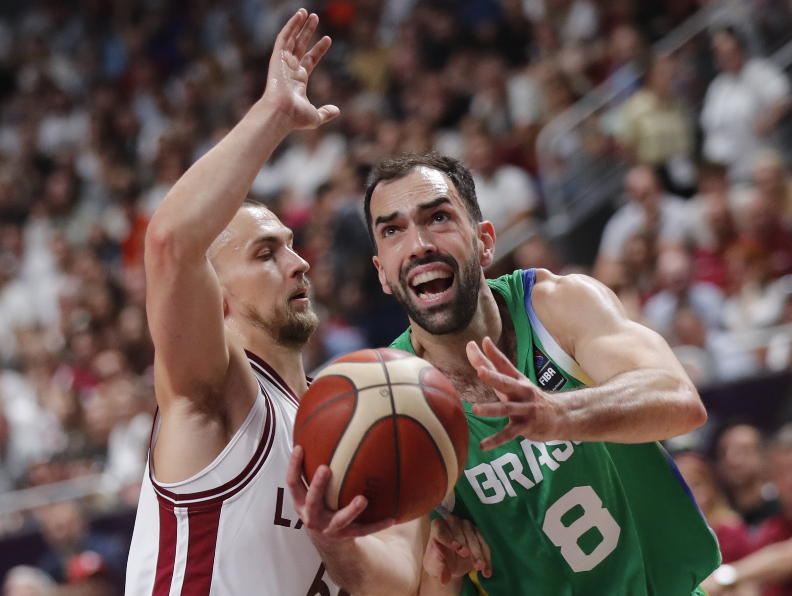 epaselect epa11465529 Kristers Zoriks of Latvia (L) in action against Vitor Benite of Brazil (R) during the FIBA Olympic Qualifying Tournament final match Latvia vs Brazil in Riga, Latvia, 07 July 2024.  EPA/TOMS KALNINS