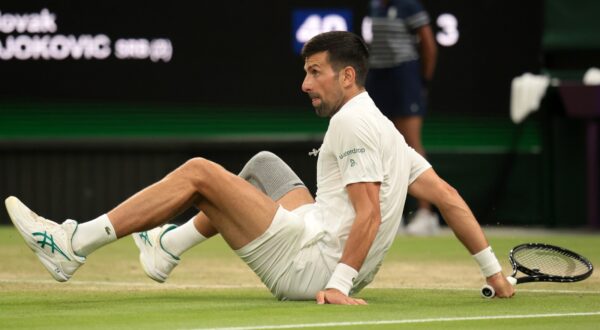 epa11467442 Novak Djokovic of Serbia falls on the ground as he plays against Holger Rune of Denmark (unseen) during their round of 16 match at the Wimbledon Championships, Wimbledon, Britain, 08 July 2024.  EPA/TIM IRELAND  EDITORIAL USE ONLY