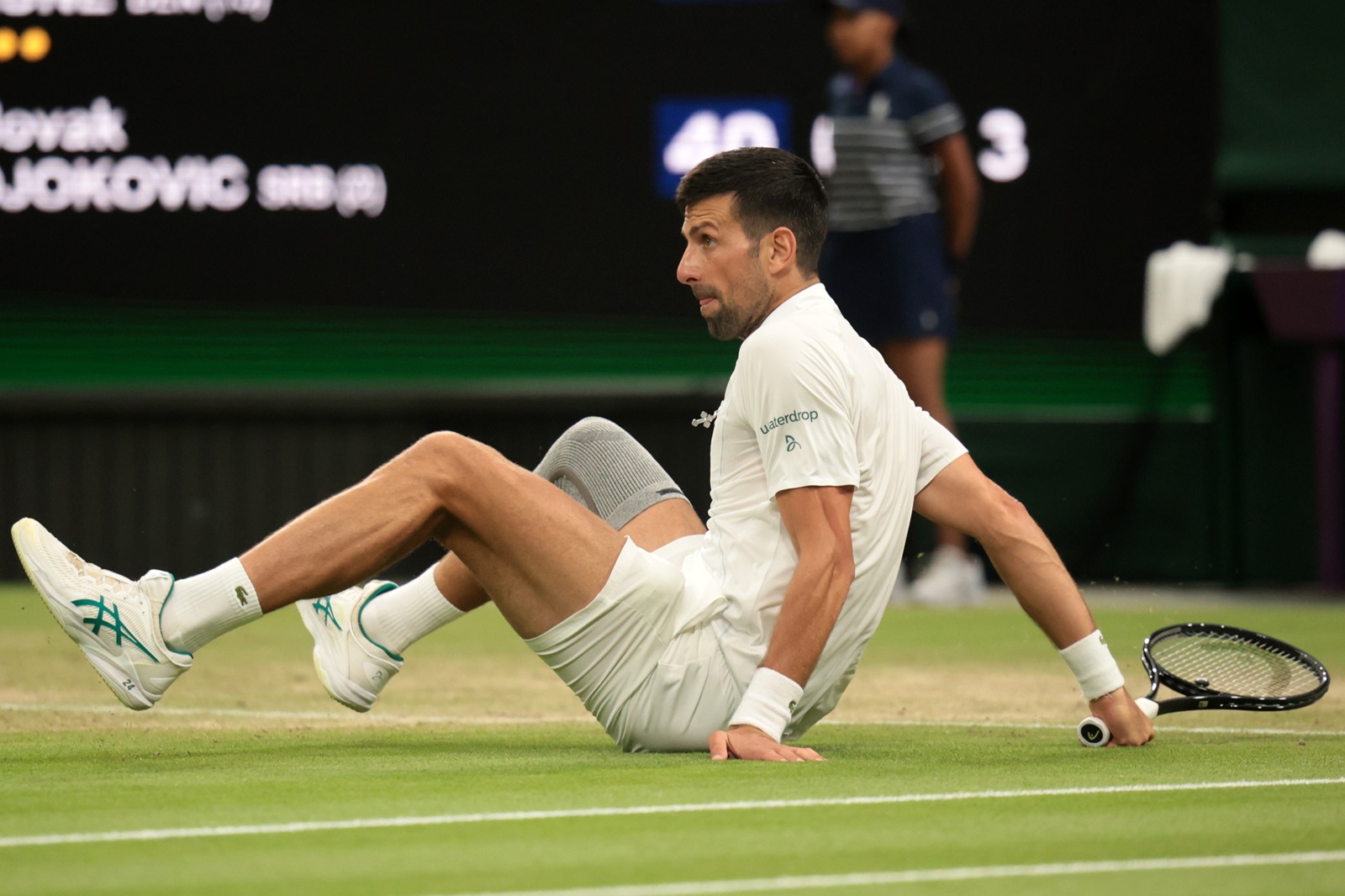 epa11467442 Novak Djokovic of Serbia falls on the ground as he plays against Holger Rune of Denmark (unseen) during their round of 16 match at the Wimbledon Championships, Wimbledon, Britain, 08 July 2024.  EPA/TIM IRELAND  EDITORIAL USE ONLY