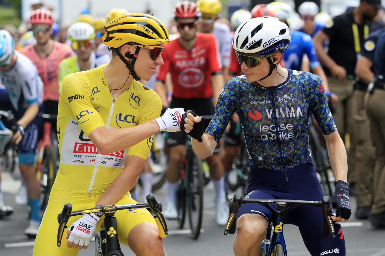 epa11472096 Yellow jersey Slovenian rider Tadej Pogacar (L) of UAE Team Emirates and Danish rider Jonas Vingegaard of Team Visma Lease a Bike bump fists as they stand at the start line of the 12th stage of the 2024 Tour de France cycling race over 203km from Aurillac to Villeneuve-sur-Lot, France, 11 July 2024.  EPA/GUILLAUME HORCAJUELO