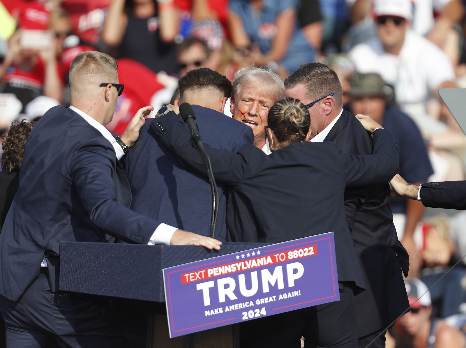 epa11476745 Former US President Donald Trump is rushed off stage by secret service after an incident during a campaign rally at the Butler Farm Show Inc. in Butler, Pennsylvania, USA, 13 July 2024.  EPA/DAVID MAXWELL