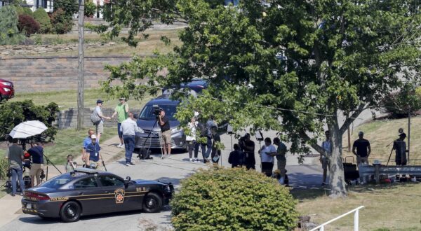 epa11477678 Law enforcement officials and members of the media near the home of 20-year-old Thomas Matthew Crooks, identified by the Federal Bureau of Investigation (FBI) as the person who attempted to assassinate former president Donald J. Trump, during an investigation in Bethel Park, Pennsylvania, USA, 14 July 2024. Crooks was killed by police after shooting and injuring Trump during a rally in Butler, Pennsylvania on 13 July.  EPA/DAVID MAXWELL