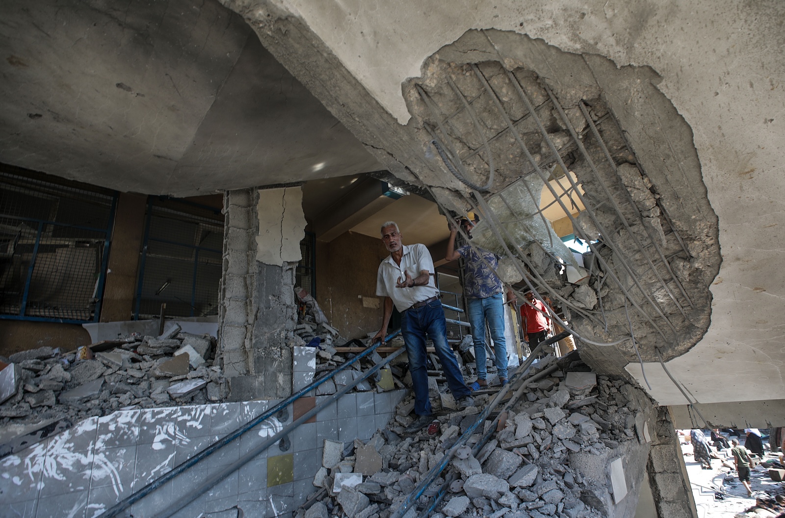 epa11478787 Palestinians inspect a damaged UNRWA school following an Israeli air strike in Al Nuseirat refugee camp, central Gaza Strip, 14 July 2024.  At least 12 people were killed following an Israeli air strike in the camp, according to the Palestinian Ministry of Health. The Israeli military stated on 14 July, that the Israeli Air Force (IAF) struck the area of UNRWA's Abu Oraiban School School building in Nuseirat, claiming that the location served as a 'hideout and operational infrastructure' to direct and carry attacks against Israeli troops operating in the Gaza Strip. More than 38,000 Palestinians and over 1,400 Israelis have been killed, according to the Palestinian Health Ministry and the Israel Defense Forces (IDF), since Hamas militants launched an attack against Israel from the Gaza Strip on 07 October 2023, and the Israeli operations in Gaza and the West Bank which followed it.  EPA/MOHAMMED SABER