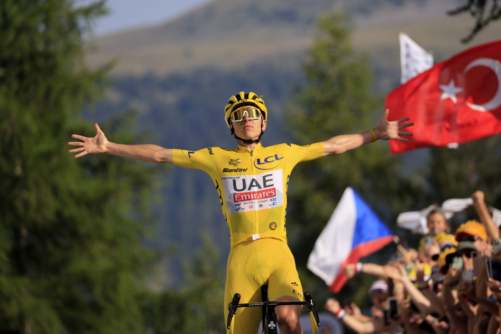 epa11489401 Yellow jersey Slovenian rider Tadej Pogacar of UAE Team Emirates celebrates as he crosses the finish line and winning the 20th stage of the 2024 Tour de France cycling race over 132km from Nice to Col de la Couillole, France, 20 July 2024.  EPA/GUILLAUME HORCAJUELO