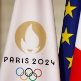 epa11491639 A flag with the Paris 2024 logo (L), a EU flag (C) and a French flag (R), displayed during a reception for international journalists accredited for the Paris 2024 Olympic Games, at the Elysee Presidential Palace, in Paris, France, 22 July 2024, ahead of Paris 2024 Olympic and Paralympic games.  EPA/LUDOVIC MARIN / POOL  MAXPPP OUT
