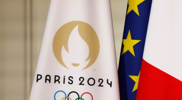 epa11491639 A flag with the Paris 2024 logo (L), a EU flag (C) and a French flag (R), displayed during a reception for international journalists accredited for the Paris 2024 Olympic Games, at the Elysee Presidential Palace, in Paris, France, 22 July 2024, ahead of Paris 2024 Olympic and Paralympic games.  EPA/LUDOVIC MARIN / POOL  MAXPPP OUT