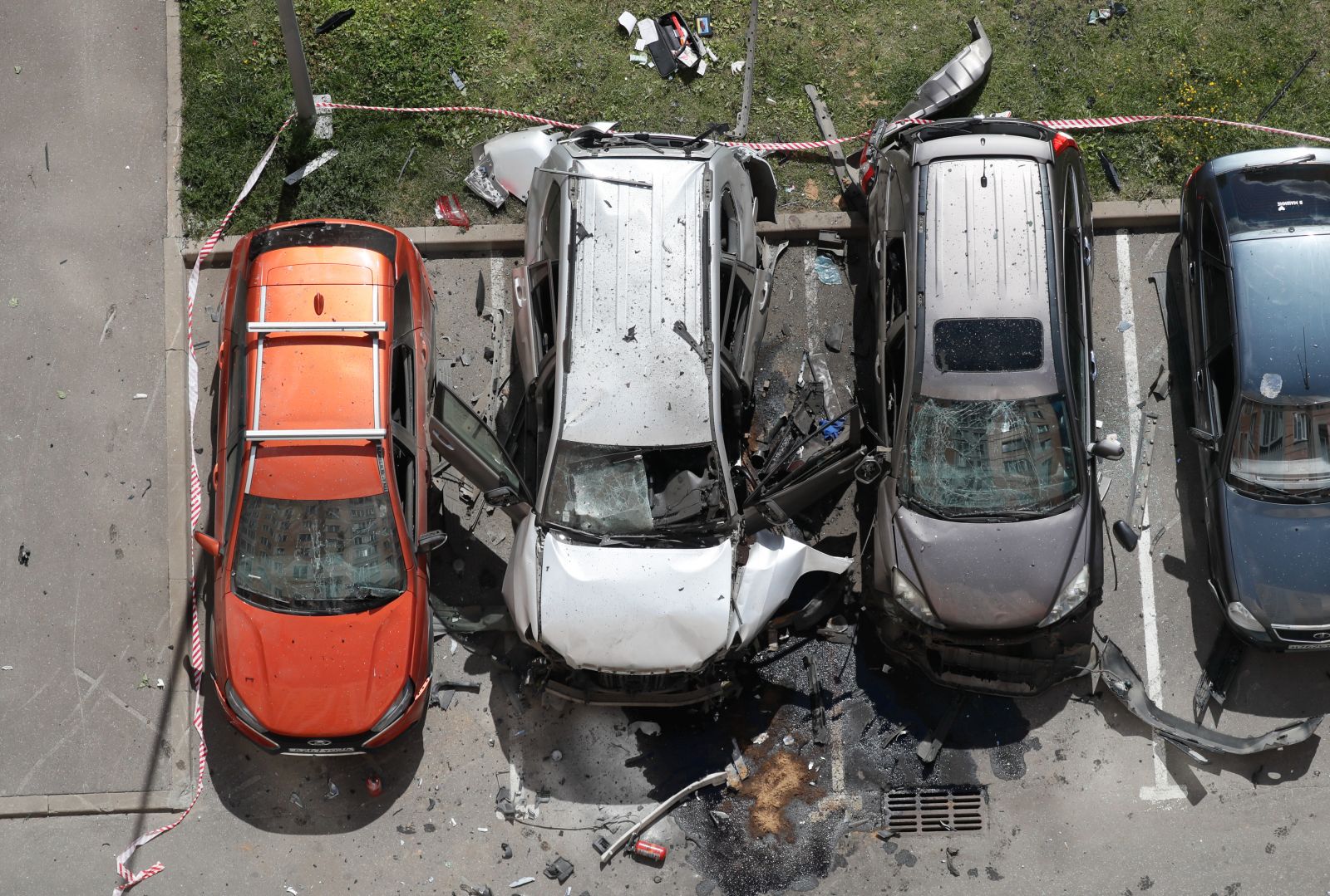 epa11493607 A view of the site of a car blast in Moscow, Russia, 24 July 2024. At least two people have been injured after an unidentified object detonated in a car in a parking lot in the north of the capital Moscow, Interior Ministry spokeswoman Irina Volk wrote on telegram. The injured were transported by ambulance to a medical facility, her statement added. Police officers are investigating the incident.  EPA/YURI KOCHETKOV