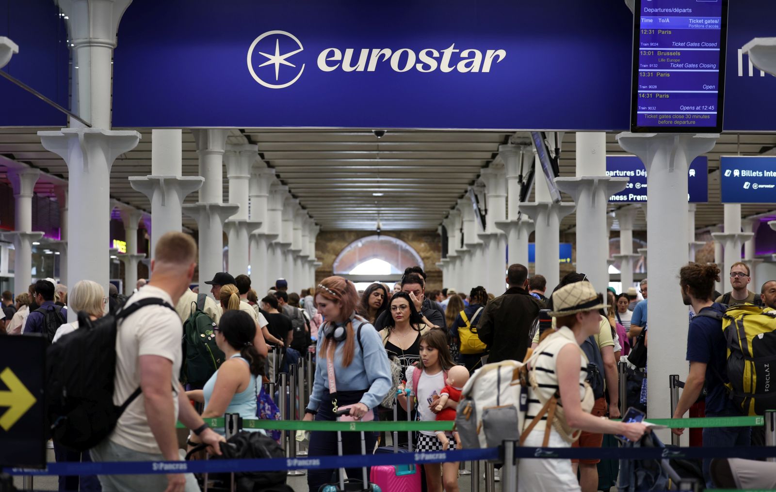 epa11497102 Rail passengers queue up at Eurostar rail terminal at St. Pancras International station in London, Britain, 26 July 2024. Eurostar has cancelled some trains from London to Paris due to arson attacks on the French rail network. Cancellations may continue into the weekend.  France's high speed rail network TGV was severely disrupted on 26 July following a 'massive attack', according to French train operator SNCF, just hours before the opening ceremony of the Paris 2024 Olympic games.  EPA/ANDY RAIN