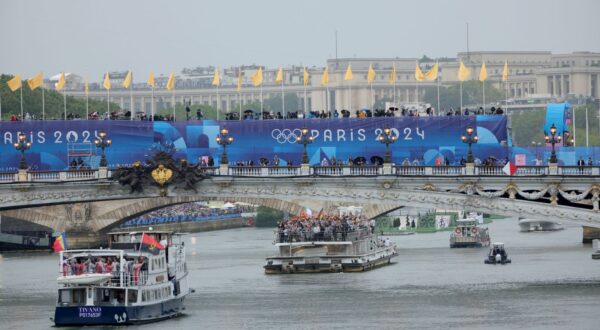 epa11497633 Athletes cruise down the Seine river during the Opening Ceremony of the Paris 2024 Olympic Games, in Paris, France, 26 July 2024.  EPA/Teresa SUAREZ