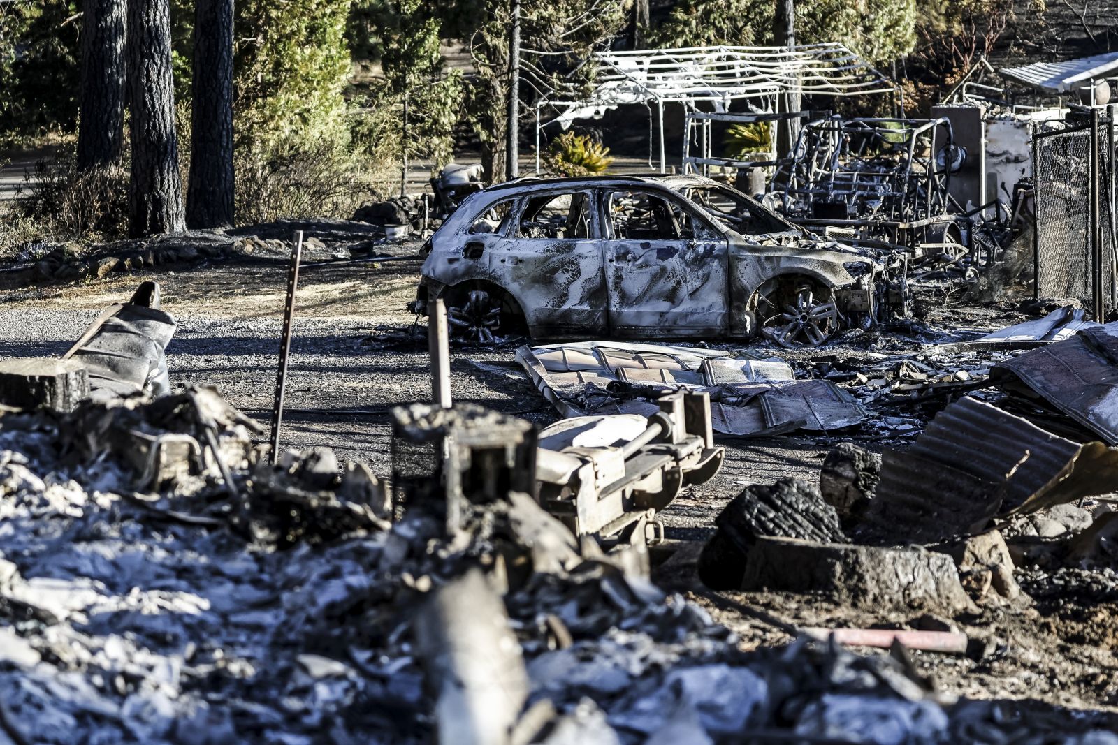 epa11498494 The burned remains destroyed by the Park Fire, which has currently burned  over 170,000 acres according to the California Department of Forestry and Fire Protection (Cal Fire), in Butte County, California, USA, 26 July 2024. According to a press release from Butte County District Attorney Mike Ramsey, a 42-year-old man from Chico, California was arrested for allegedly pushing a burning car into a gully which set off the Park Fire. As of today, according to Cal Fire, the fire was 0 percent contained.  EPA/JOHN G. MABANGLO