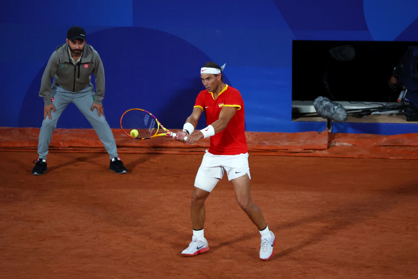 epa11500425 Rafael Nadal and Carlos Alcaraz (not pictured) of Spain in action during their Men's Doubles first round match against Maximo Gonzalez and Andres Molteni of Argentina at the Tennis competitions in the Paris 2024 Olympic Games, at the Roland Garros in Paris, France, 27 July 2024.  EPA/DIVYAKANT SOLANKI