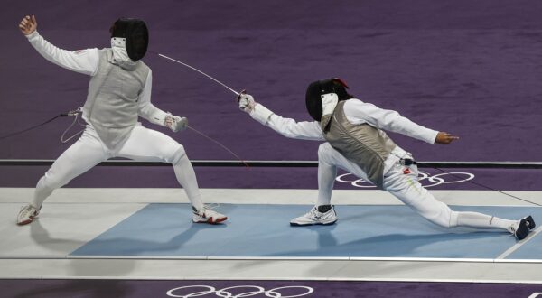 epa11505169 Blake Broszus (L) of Canada and Kruz Schembri (R) of US Virgin Islands in action during the Men Foil Individual Table of 64 in the Fencing competitions in the Paris 2024 Olympic Games, at the Grand Palais in Paris, France, 29 July 2024.  EPA/YOAN VALAT