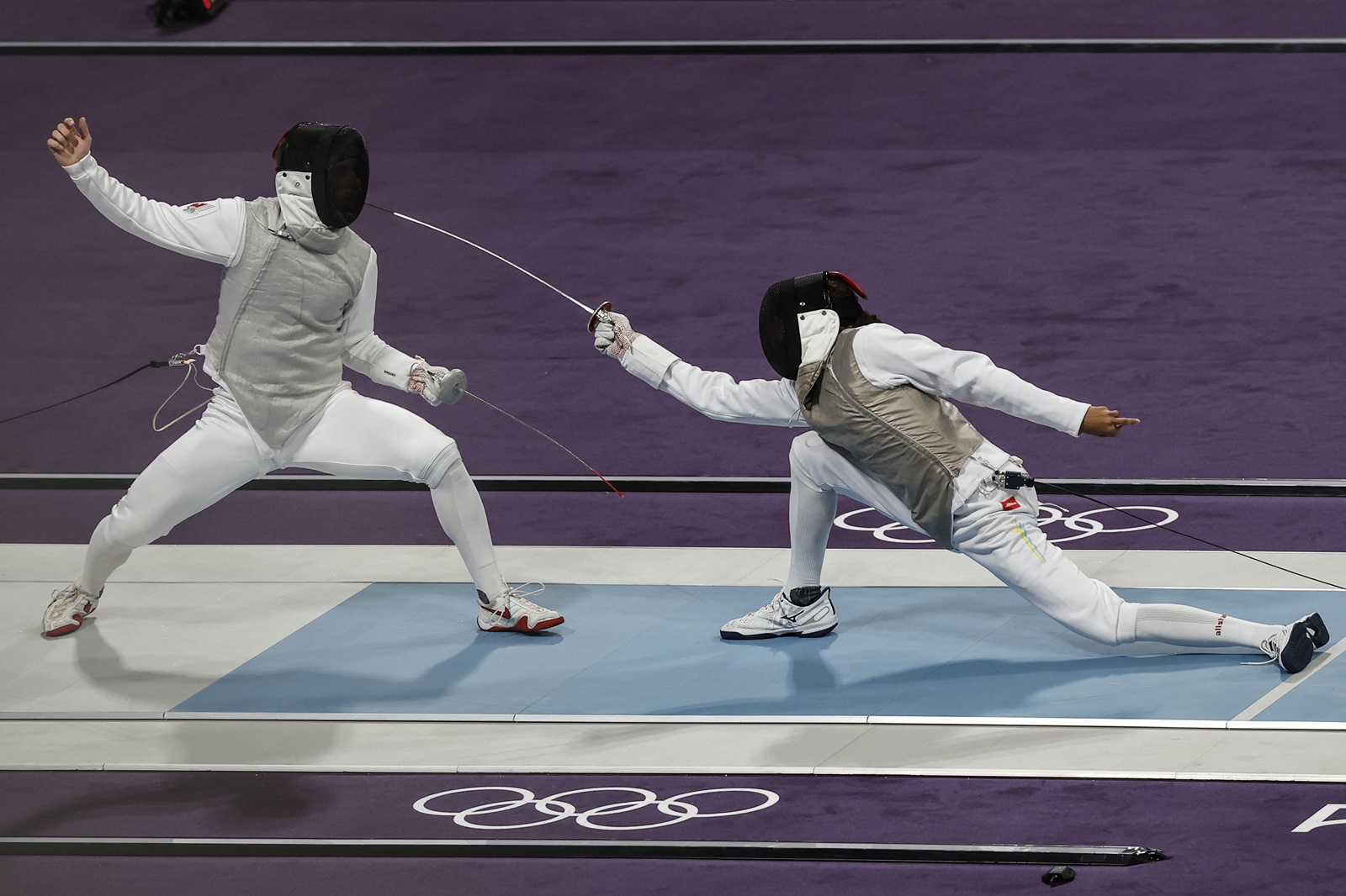 epa11505169 Blake Broszus (L) of Canada and Kruz Schembri (R) of US Virgin Islands in action during the Men Foil Individual Table of 64 in the Fencing competitions in the Paris 2024 Olympic Games, at the Grand Palais in Paris, France, 29 July 2024.  EPA/YOAN VALAT