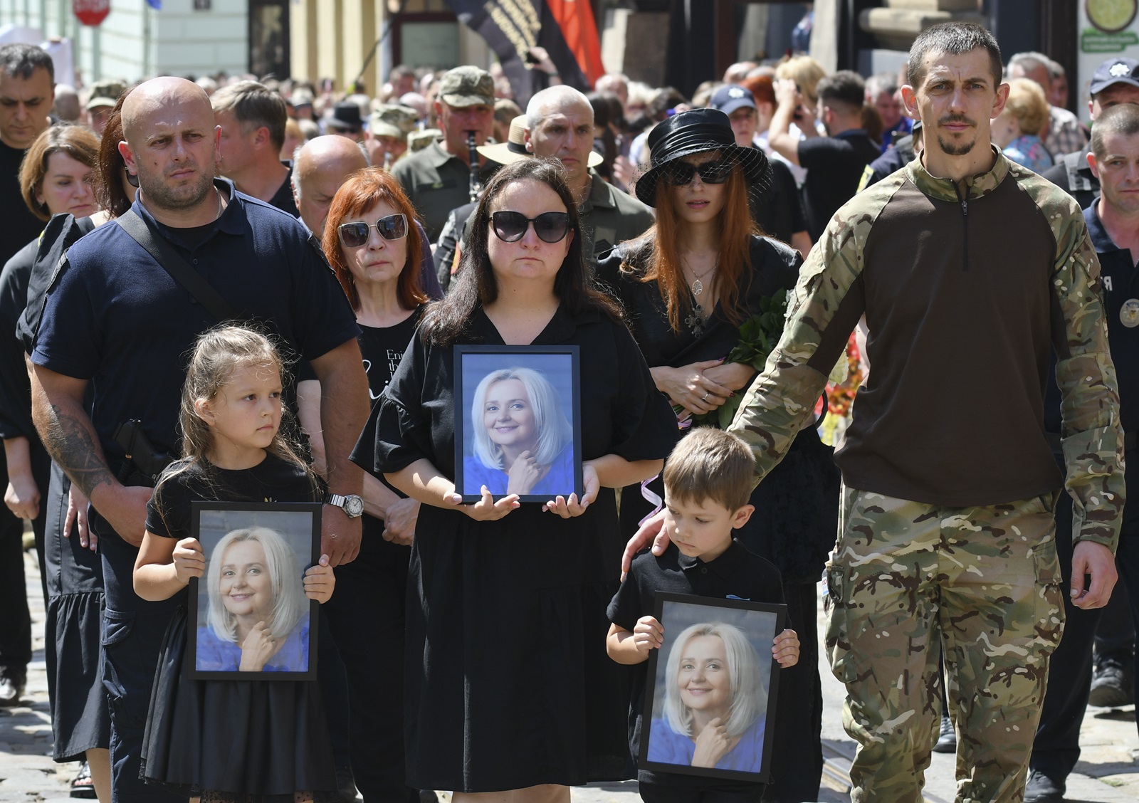 epa11491488 Relatives of Ukrainian former MP Iryna Farion carry her photos during her funeral procession in Lviv, Ukraine, 22 July 2024. Linguist and nationalist politician Iryna Farion died in hospital on the evening of 19 July after an unknown person shot her earlier that day near her house in Lviv, the National Police said. According to Ukrainian President Volodymyr Zelensky, the National Police of Ukraine and the Security Service of Ukraine have been deployed to search for the shooter as the investigation into her murder was ongoing.  EPA/MYKOLA TYS