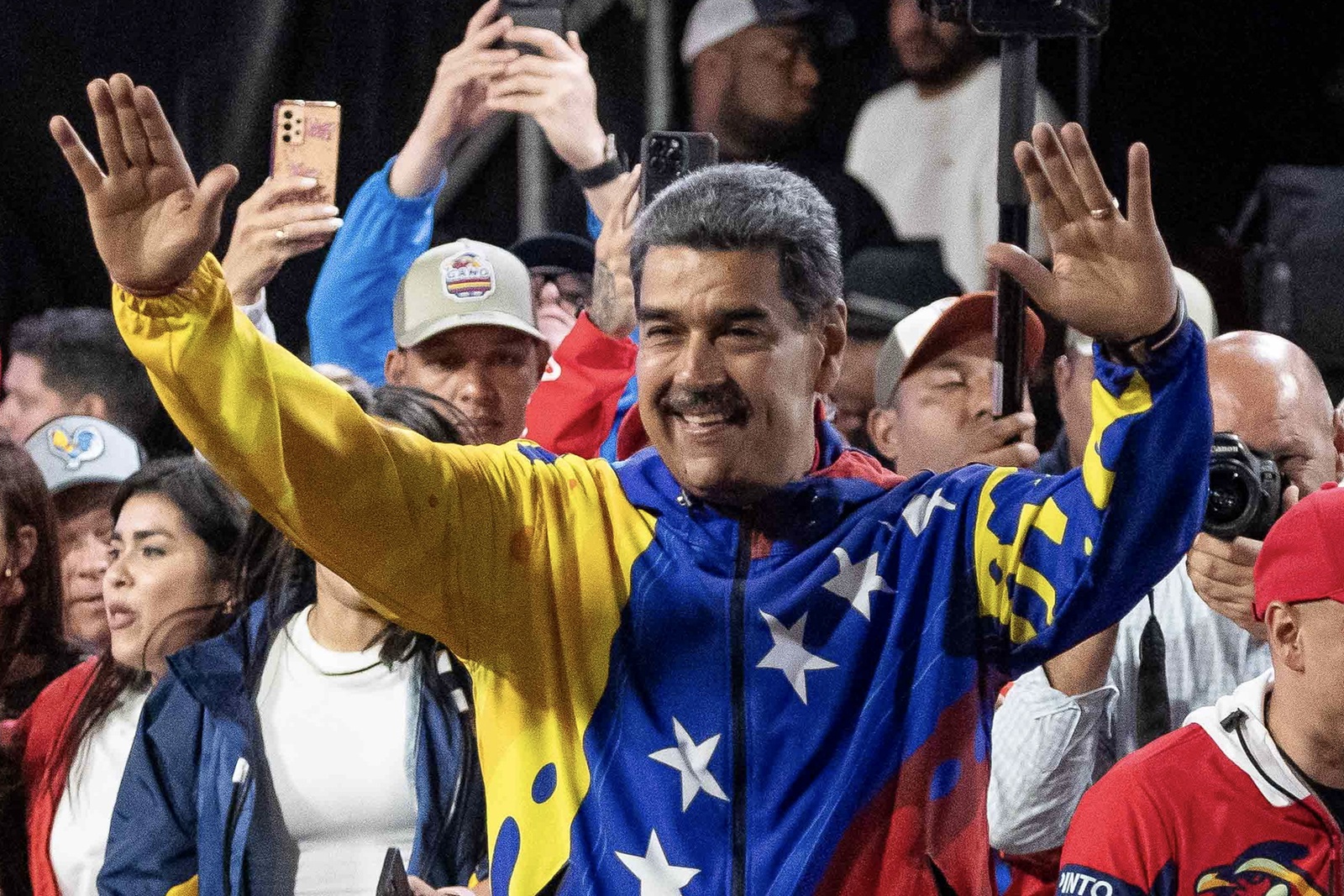 epa11504913 Venezuelan President Nicolas Maduro (C) celebrates after partial results were announced by the electoral council, in Caracas, Venezuela, 29 July 2024. According to the first report from the National Electoral Council (CNE), Maduro was re-elected for a third consecutive term in the elections held on 28 July, in which he obtained 51.2 percent of the votes (5,150,092 votes), while the standard-bearer of the majority opposition, Edmundo Gonzalez Urrutia, obtained 4,445,978 votes, which represents 44.2 percent of the votes.  EPA/RONALD PENA R.