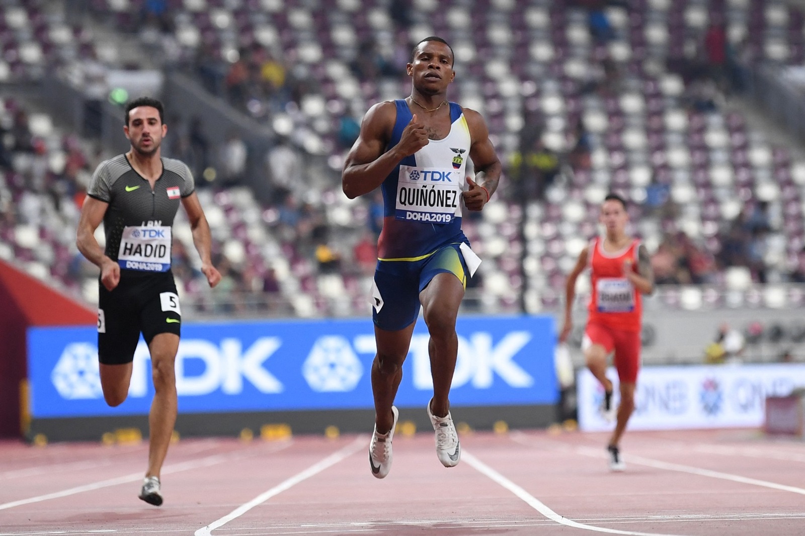 Lebanon's Noureddine Hadid (L) and Ecuador's Alex Quinonez (C) compete in the Men's 200m heats at the 2019 IAAF World Athletics Championships at the Khalifa International Stadium in Doha on September 29, 2019.,Image: 474149632, License: Rights-managed, Restrictions: , Model Release: no, Credit line: Jewel SAMAD / AFP / Profimedia